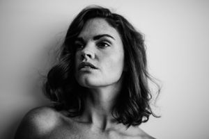 Dramatic black and white portrait with strong contrast and emotional expression.