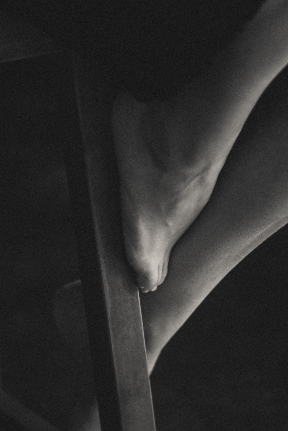 Abstract black and white close-up photograph showing dramatic shadows and lines.