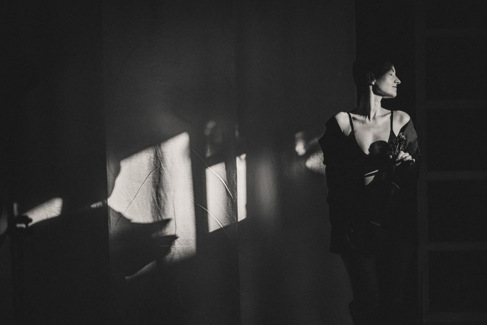 Cinematic black and white sequence with dramatic side lighting.
