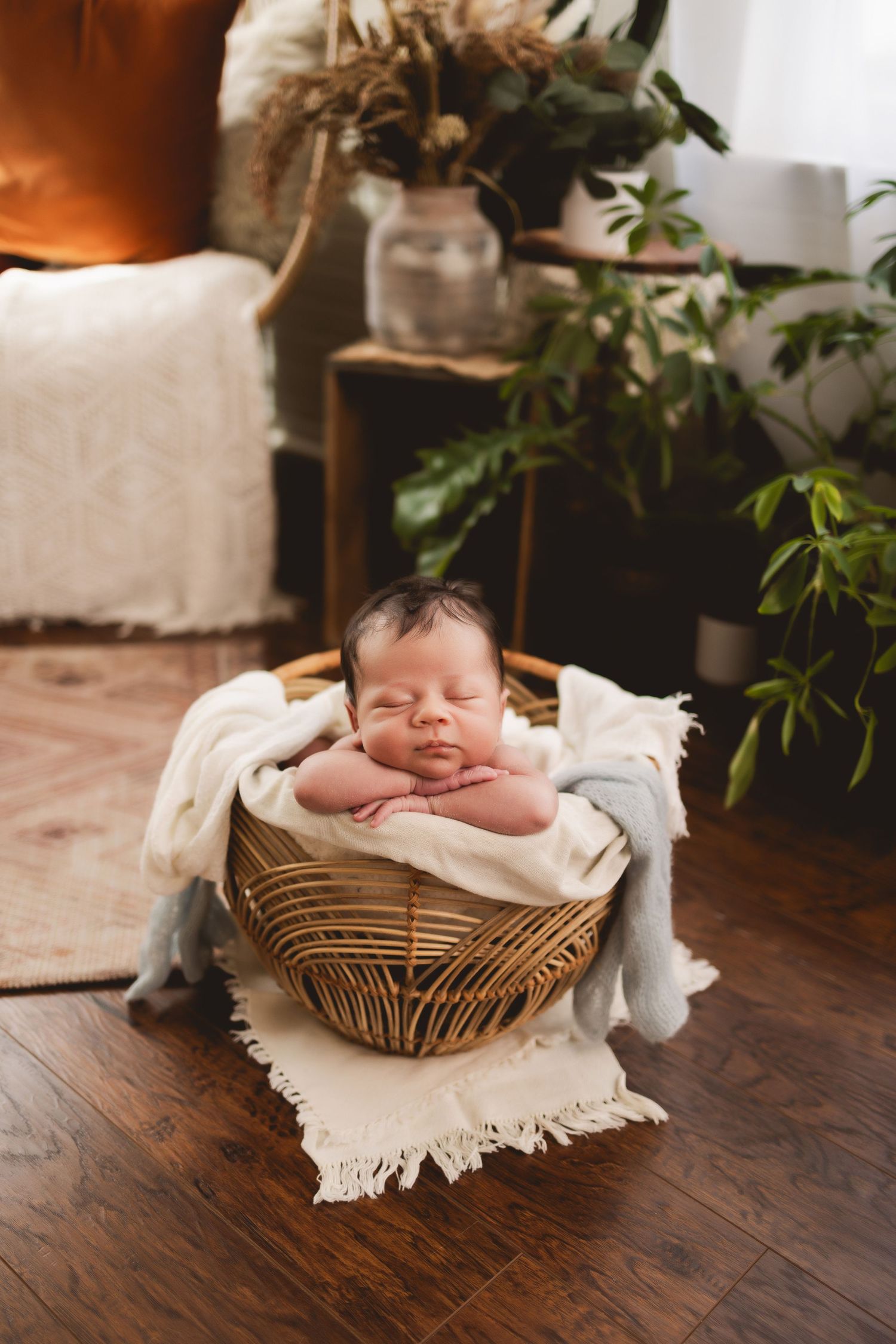 Studio newborn photo of baby in basket, captured by Urso Photography in Chattanooga.