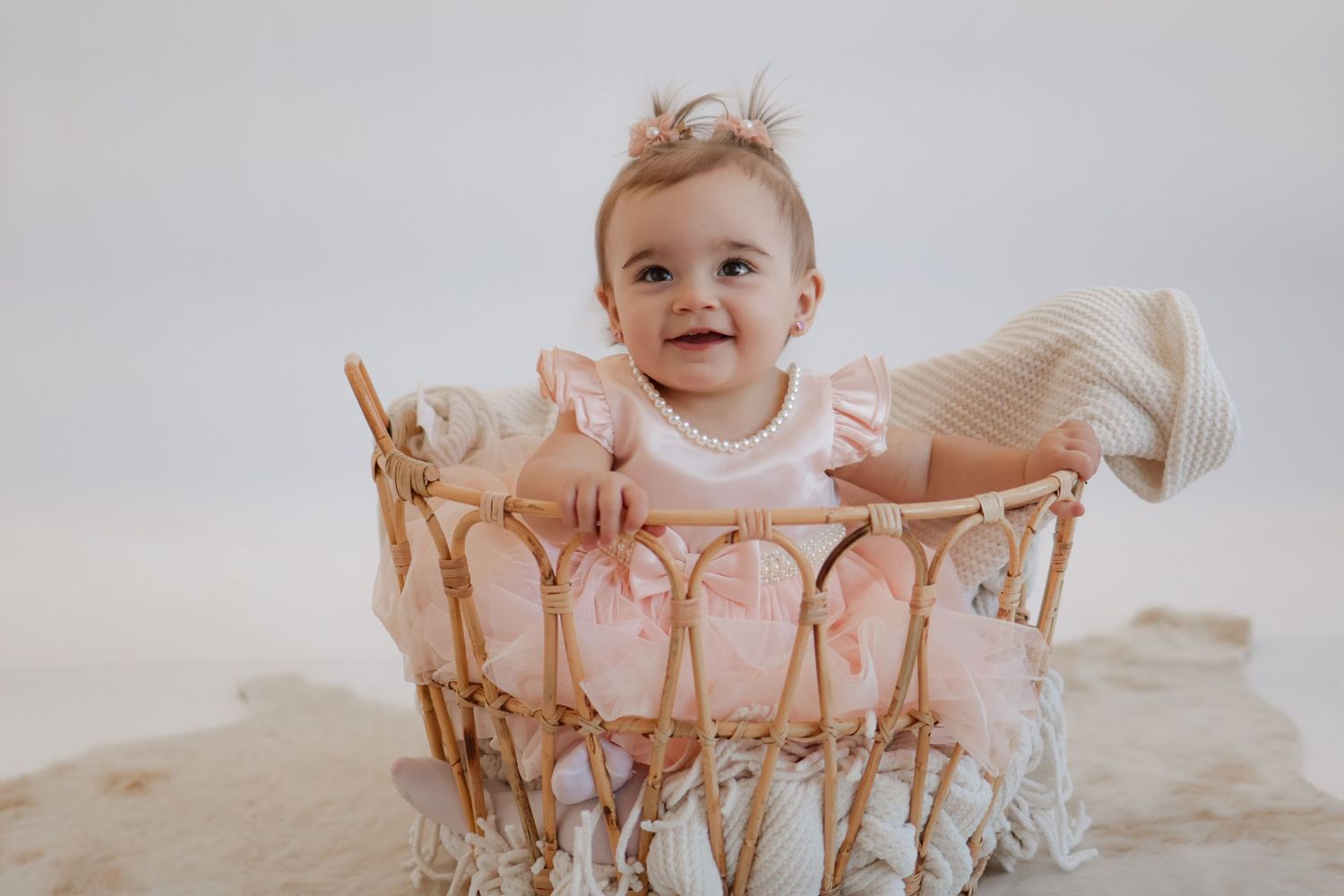 Soft pink decorative crib or basket with delicate details.