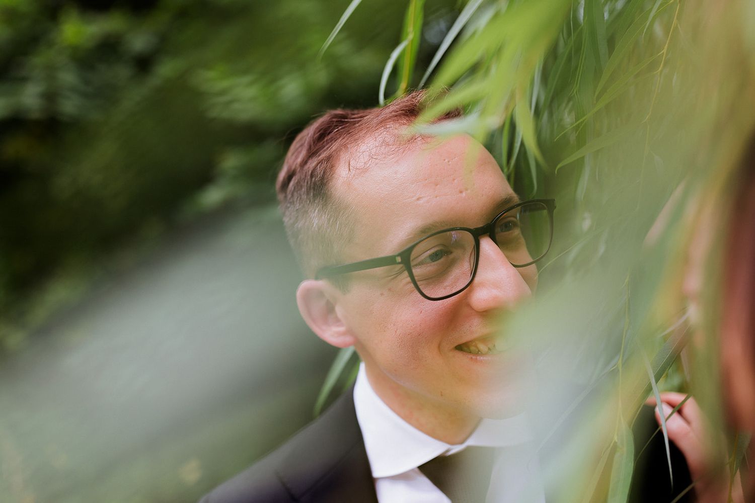Artistic close-up shot through greenery and leaves outdoors.