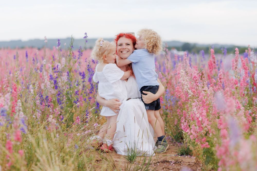 A joyful scene in a field of pink and purple wildflowers on a summer day.