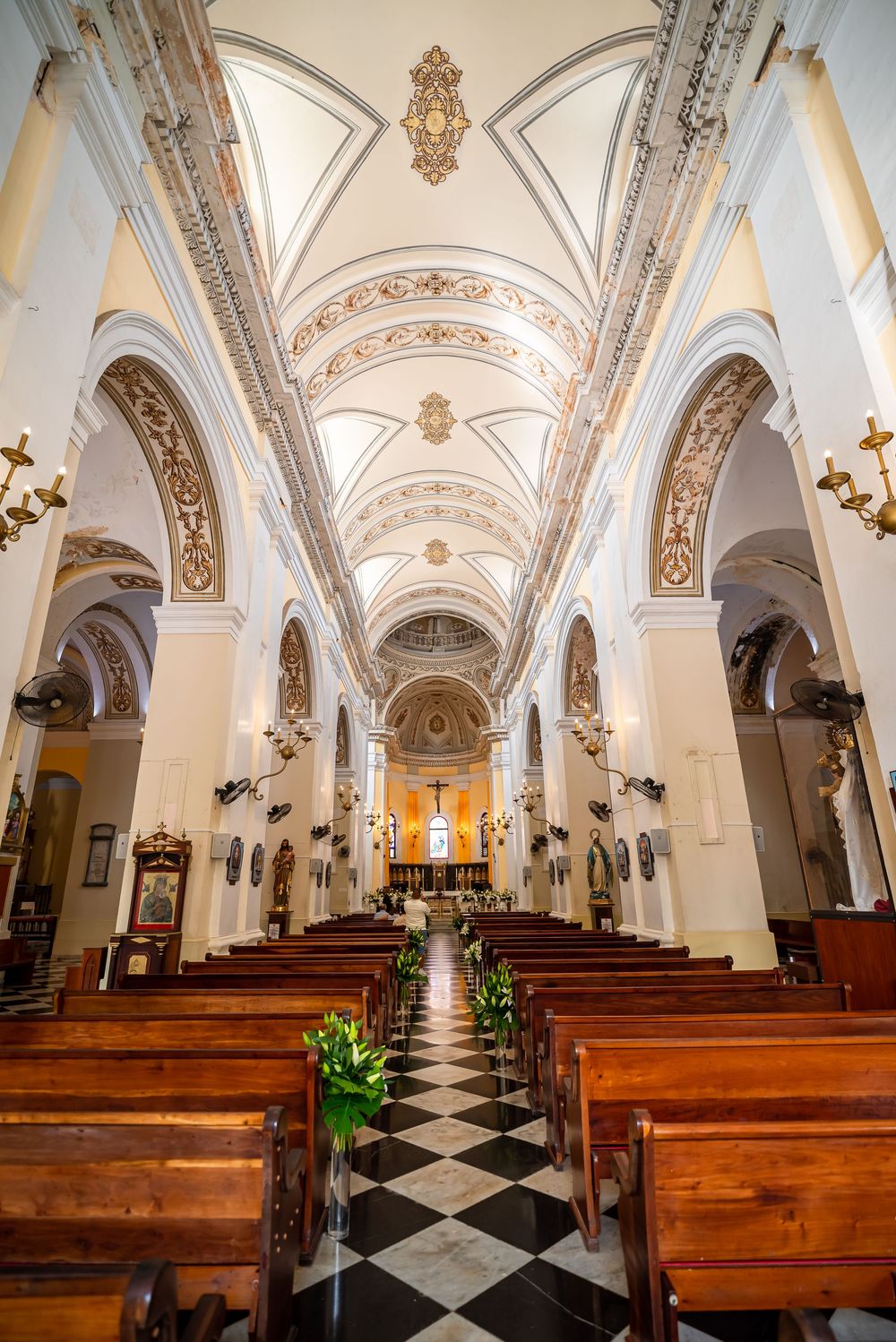 Stunning baroque church interior with vaulted ceiling and checkered marble aisle.