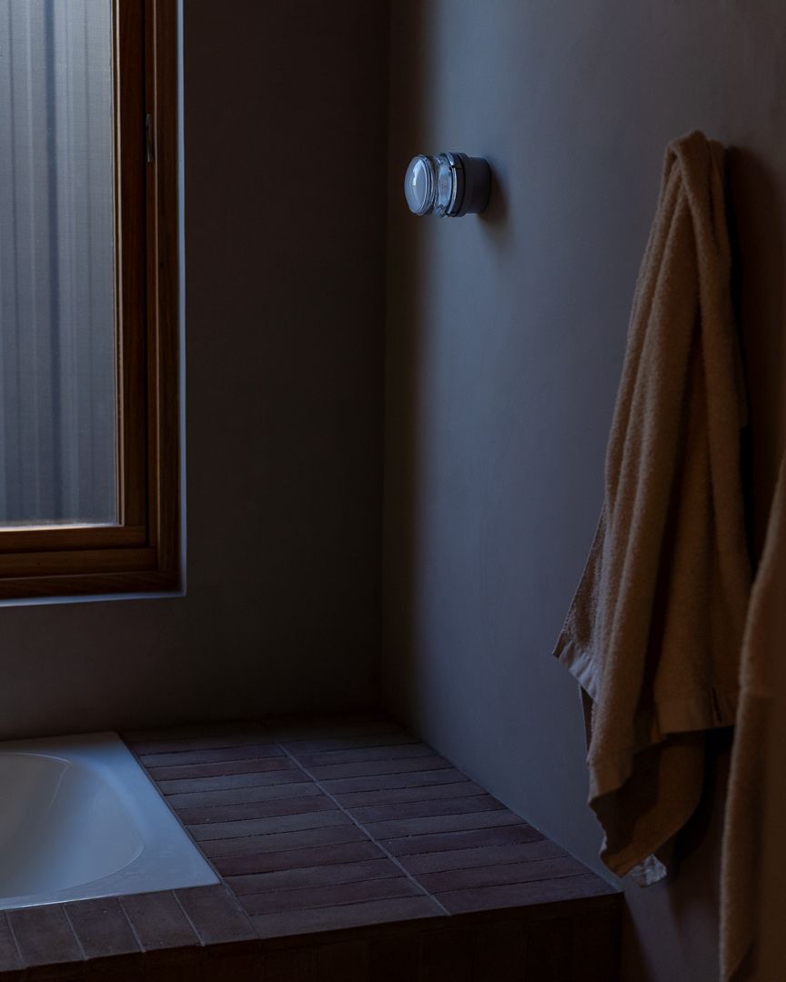 Interior design photograph of a luxurious high-end bathroom with towel and lighting in Perth