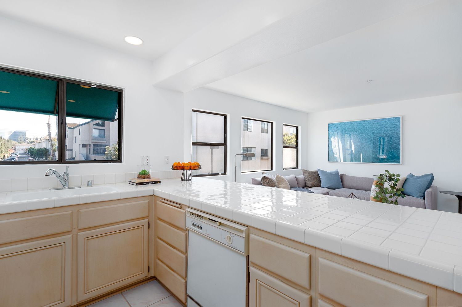 Spacious kitchen featuring beige cabinetry, white countertops, and modern appliances.
