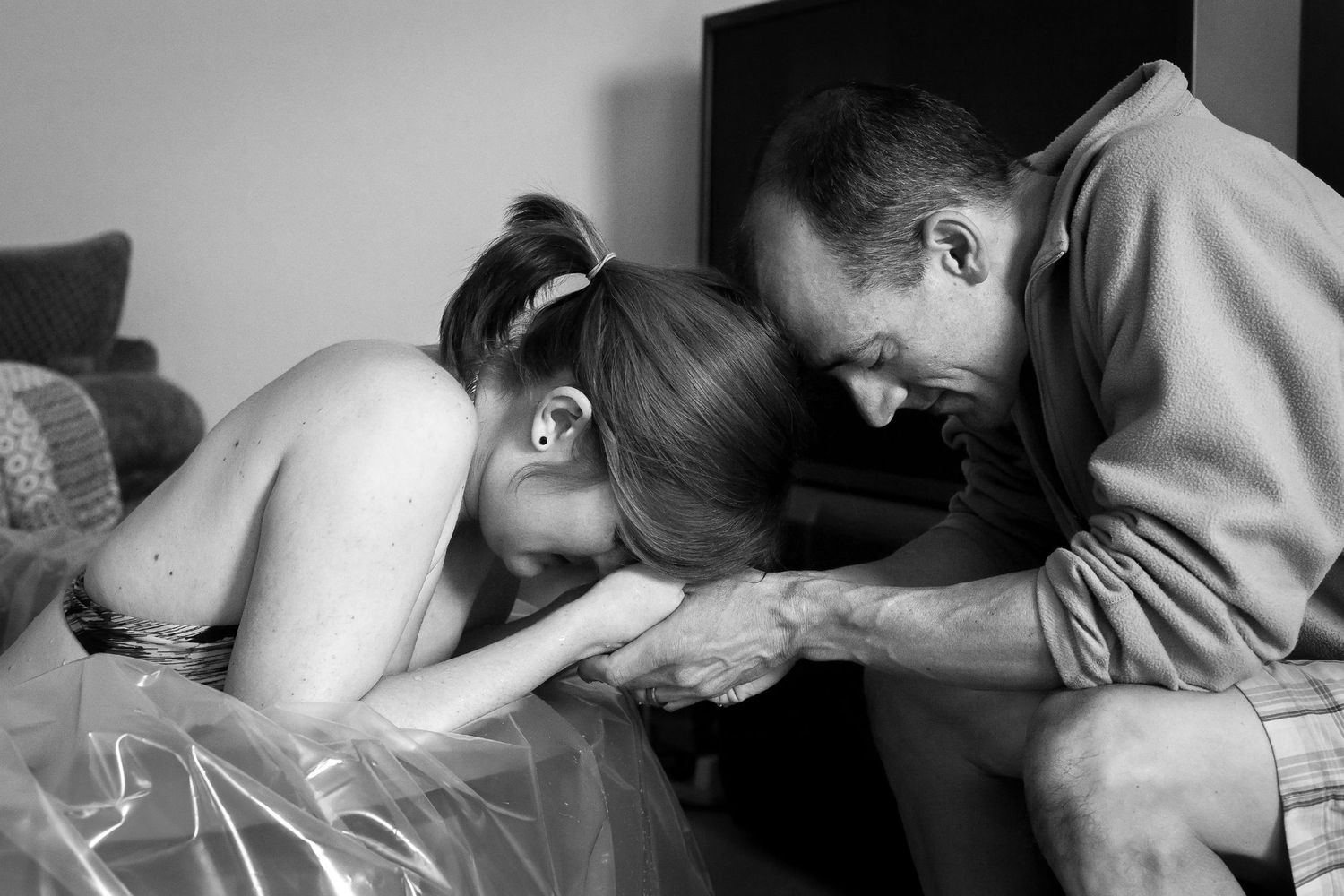 San Diego homebirth. San Diego doula. Black and white image showing a tender moment between two people sharing a quiet connection.