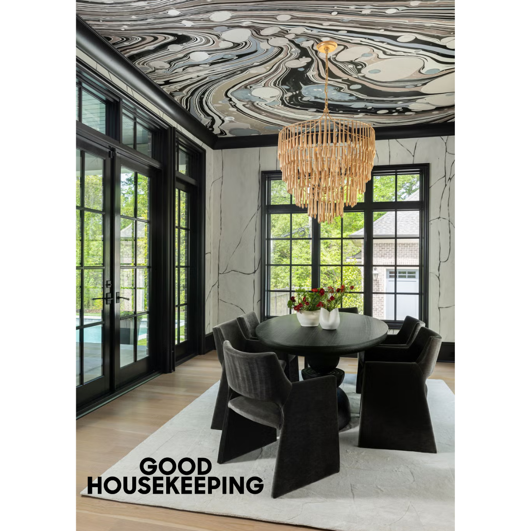Heather Ison Photography for Good Housekeeping. Elegant dining room with black chairs, ornate ceiling design, and gold chandelier.