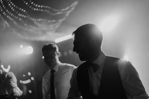 guests dancing under warm lights at vineyard wedding