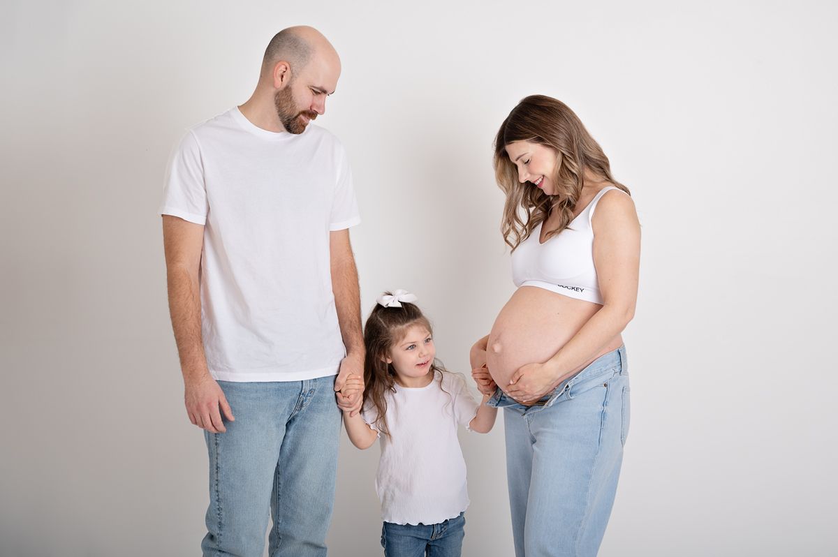 pregnant mother with her family with jeans and white t-shirts in studio Maternity Photo Session Baltimore, ON, Northumberland County.*
