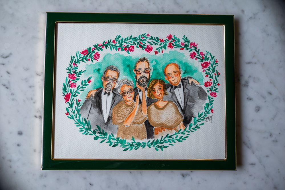 Watercolor family portrait in green frame with floral border design.