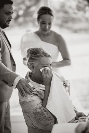 Joyful moments captured in black and white as wedding guests embrace and celebrate.