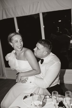 A series of black and white photos showing a romantic couple sharing intimate moments at a dinner table.
