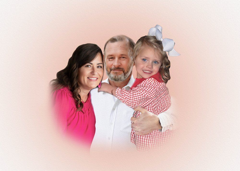 Family portrait showing loving embrace in warm pink tones.