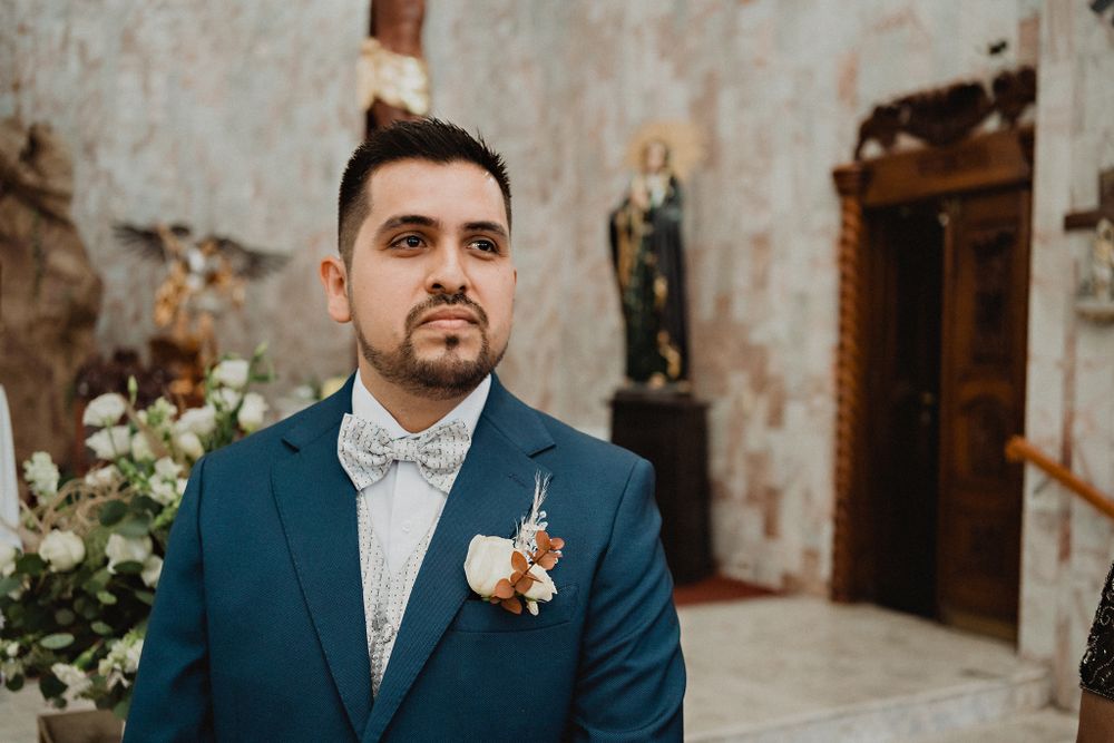 Groom eagerly waiting at the altar, capturing the anticipation and love for his bride on their wedding day