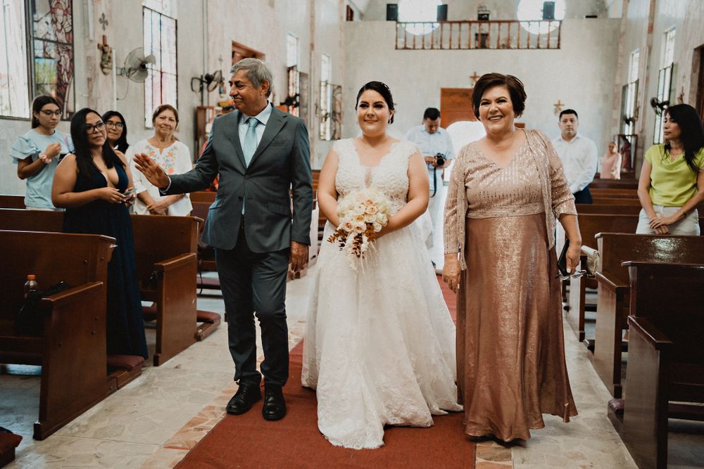 Bride walking down the aisle with her parents, a touching moment filled with love and support