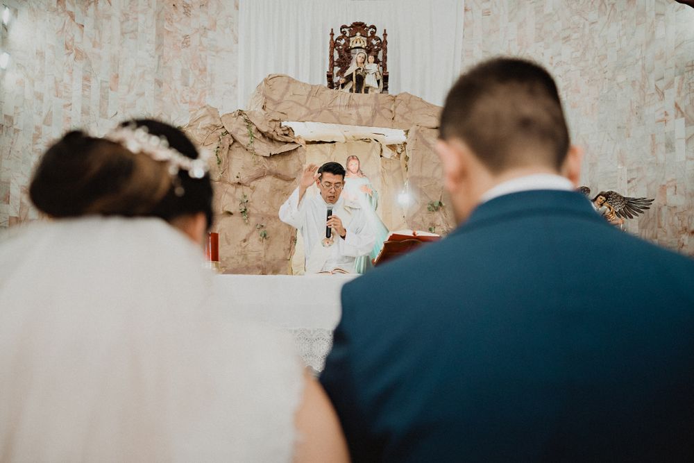Priest giving his blessing to the newlyweds, a heartfelt moment filled with love and tradition