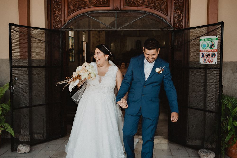 Couple exiting the church with bright smiles, celebrating their union and the beginning of their journey together