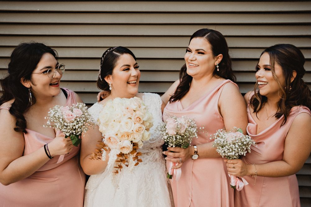 Bride with her bridesmaids during a photo session, capturing the joy and support of friendship