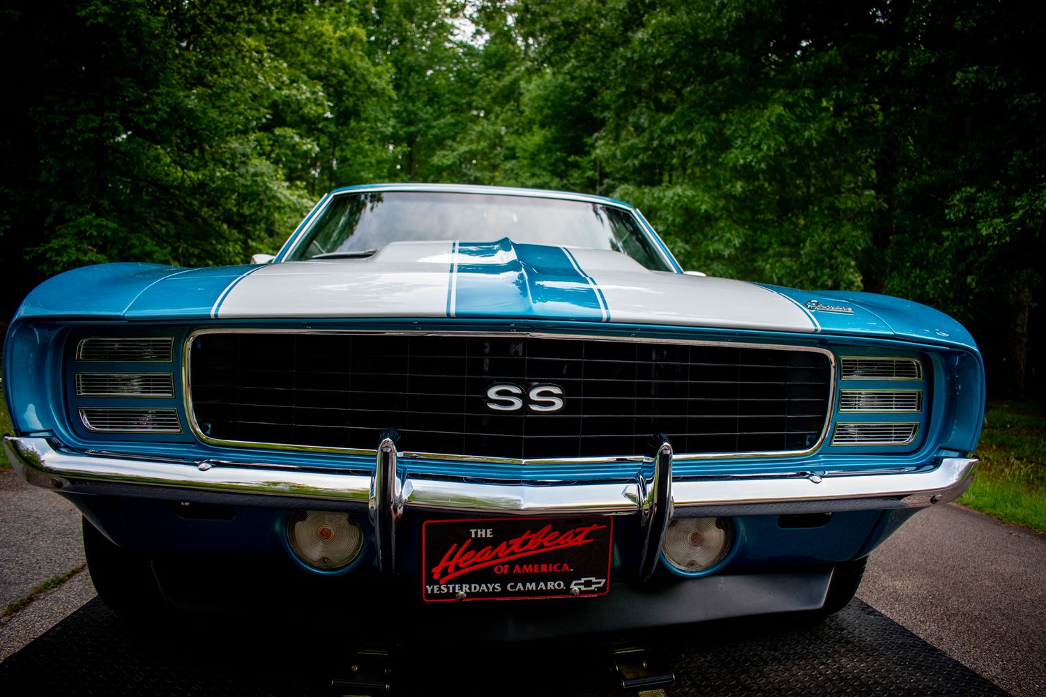 Front view of a restored blue and white Chevrolet Camaro SS muscle car.