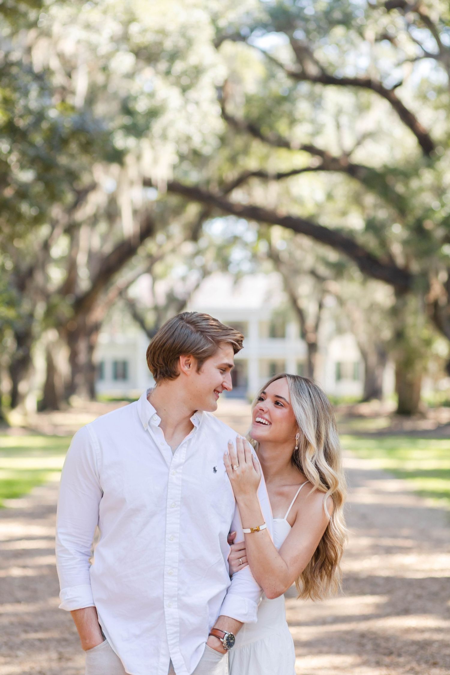Couple sharing a happy moment under Spanish moss covered trees.