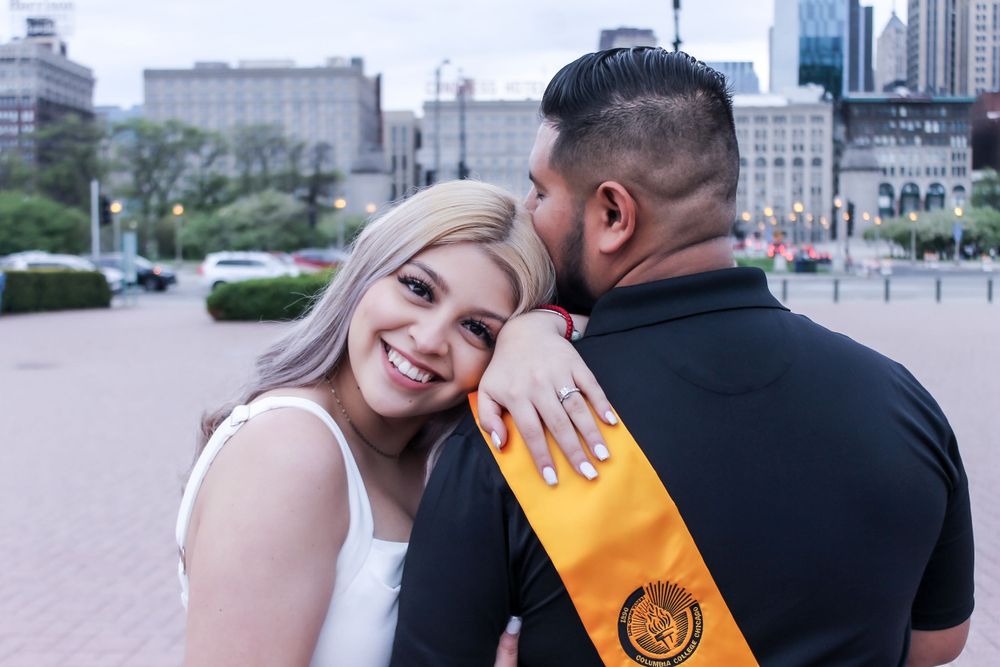 Engaged couple sharing an intimate moment in an urban setting.