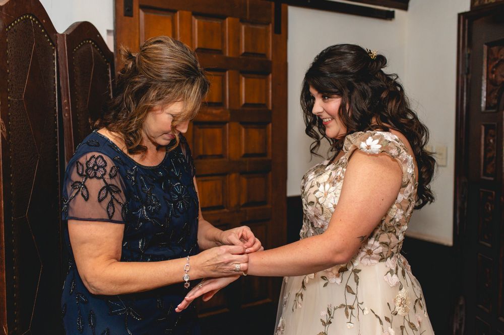 Two people sharing an intimate moment while looking at jewelry in formal attire.
