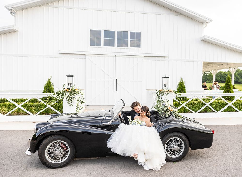 bride and groom in car, antique car, luxury wedding, wedding gown, wedding venue, nc wedding photographer, sc photographer, luxury venue, tn
