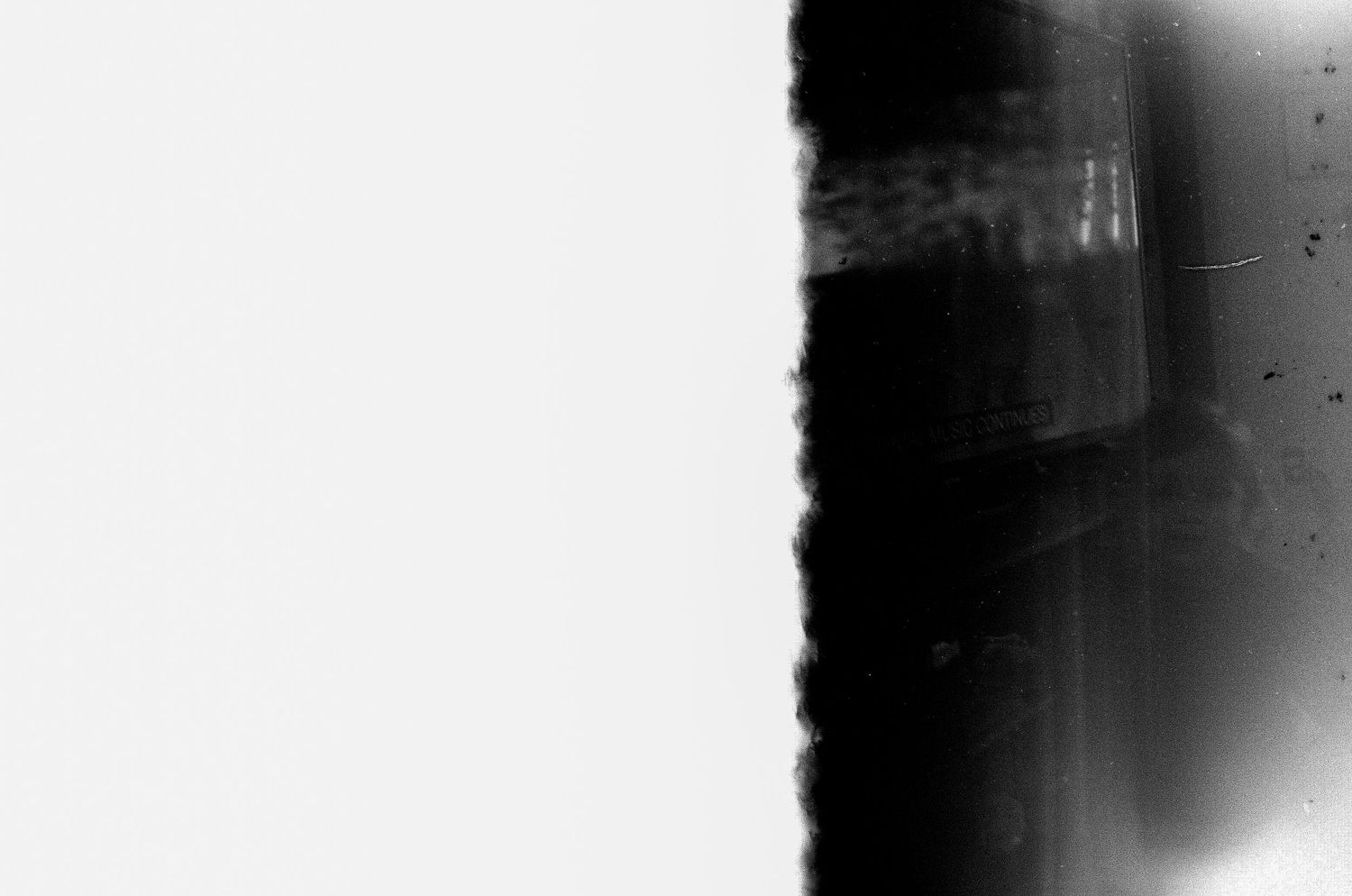 Abstract black and white photograph with strong contrast and gradient effects.
