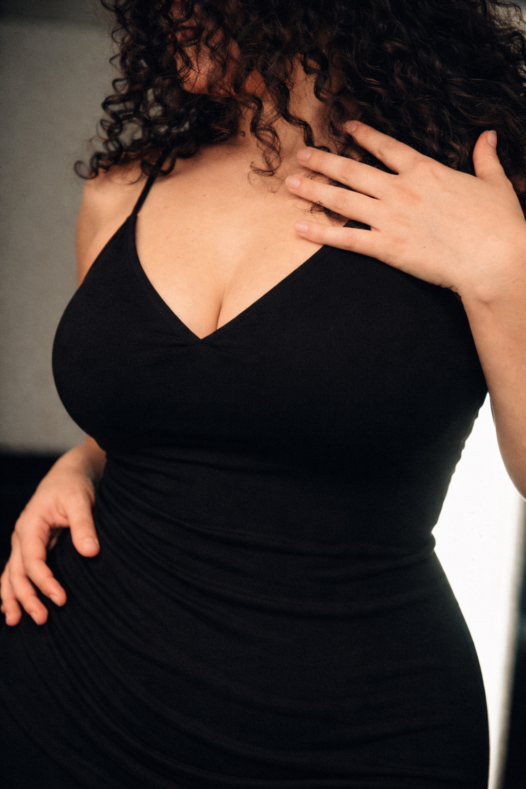 A series of black and white cropped photos showing someone in a black sleeveless top against a light background.