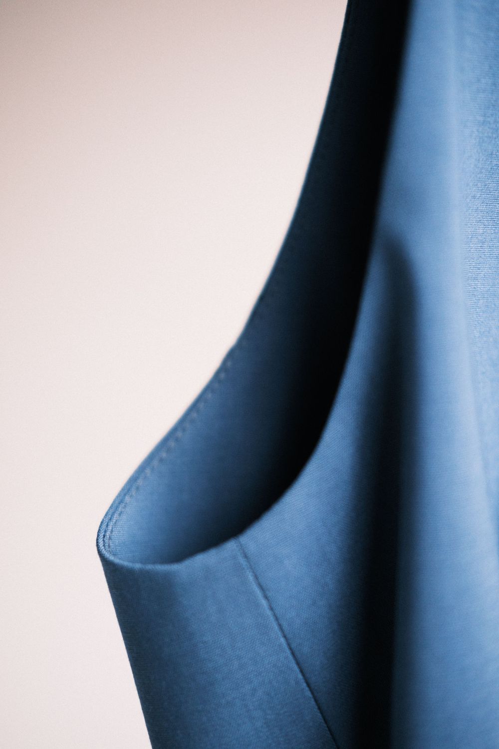 Abstract architectural detail showing curved blue walls creating a minimalist geometric pattern in cool tones.