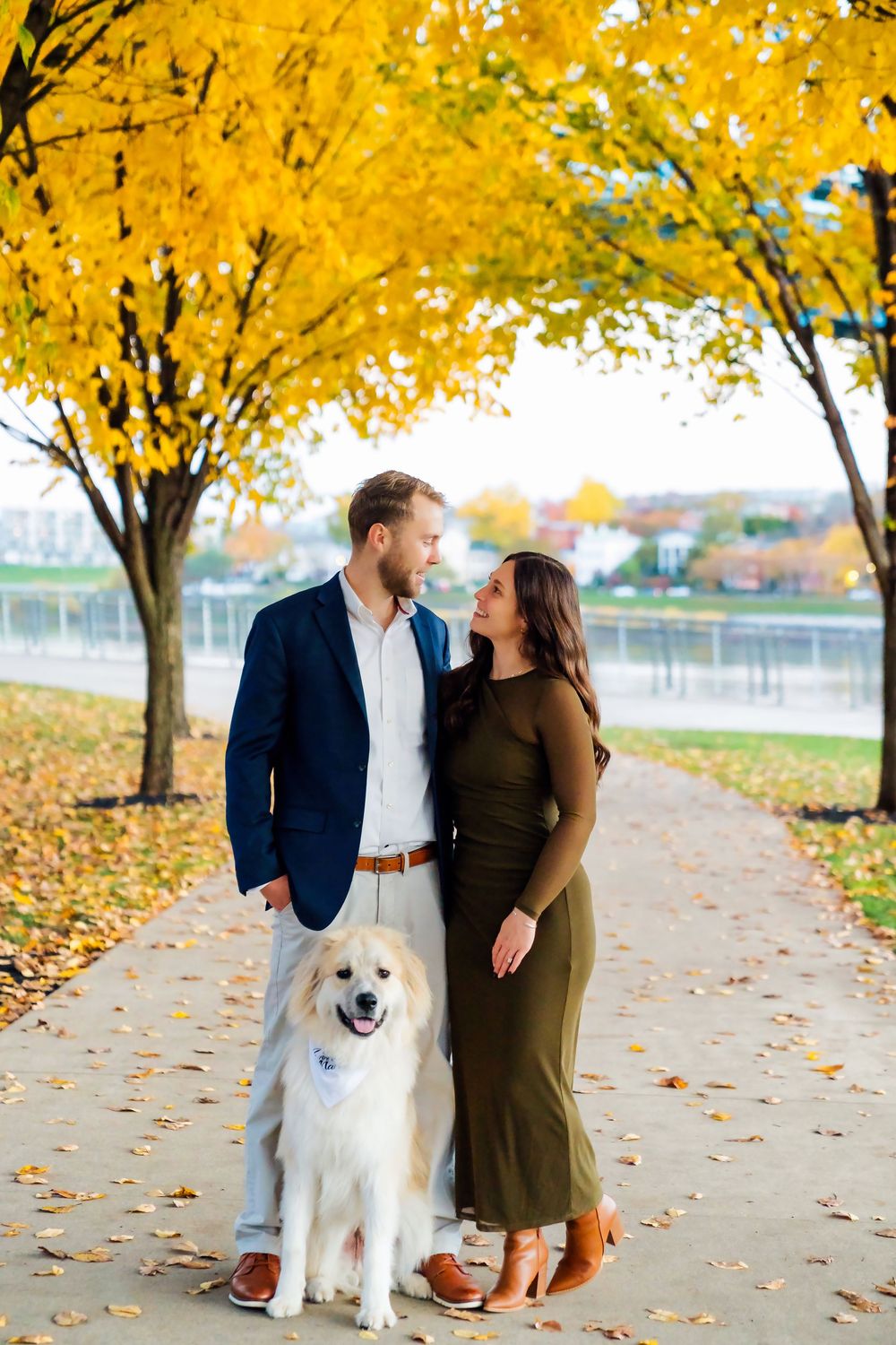 Liz and Chris's Engagement Downtown Cincinnati at Smale Park with standing with their puppy: Cincinnati Wedding Photographer