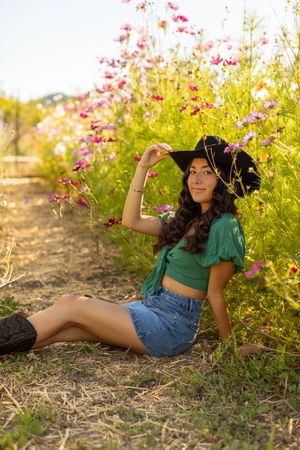 A series of outdoor portraits amidst wildflowers with pink blooms and golden sunlight creating a dreamy summer aesthetic.