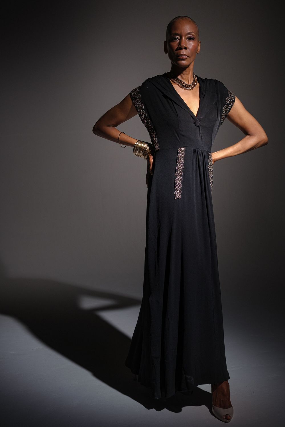 Dramatic fashion photo series showing a flowing black dress against a dark background with dynamic poses.