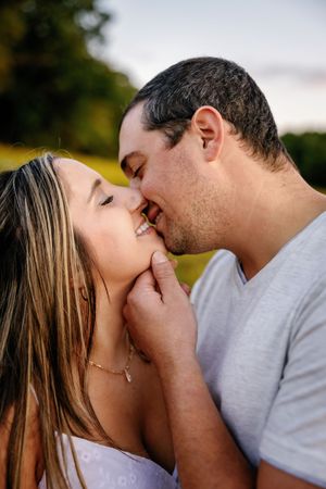A tender close-up moment between a couple during golden hour.