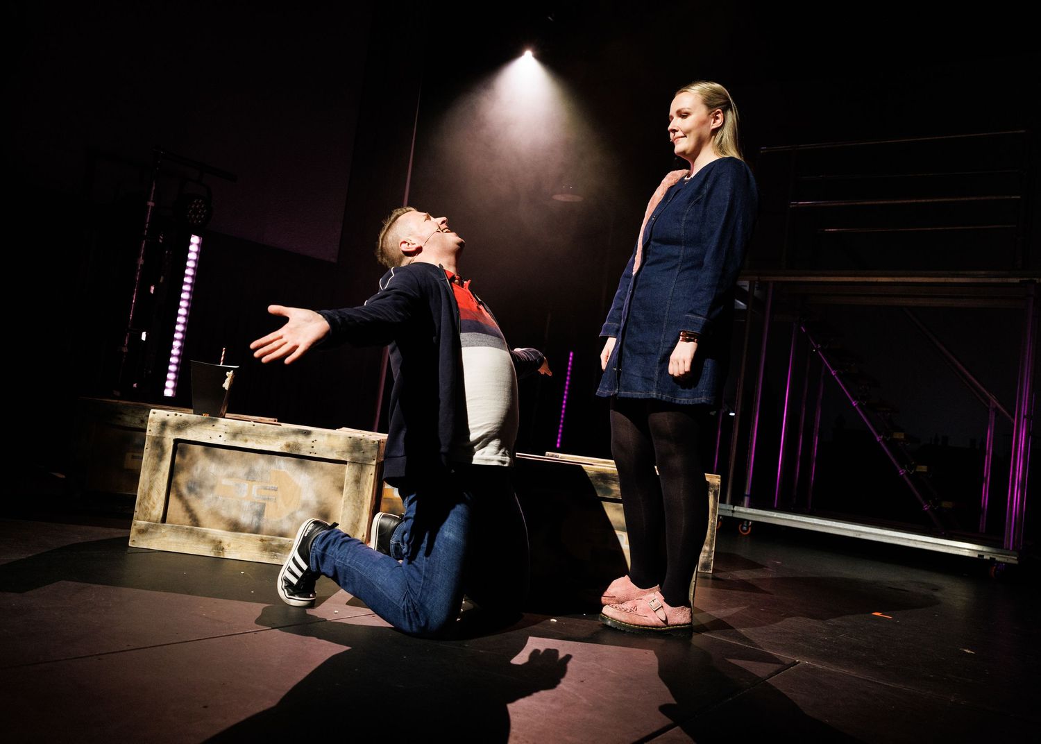 A sequence of dramatic stage performance photos showing expressive movement and gestures in dark theatrical lighting.