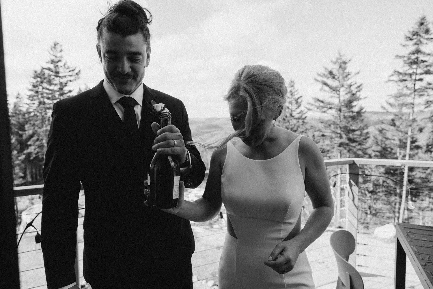 A black and white photo collage shows intimate moments from an outdoor wedding celebration in a scenic mountain setting.
