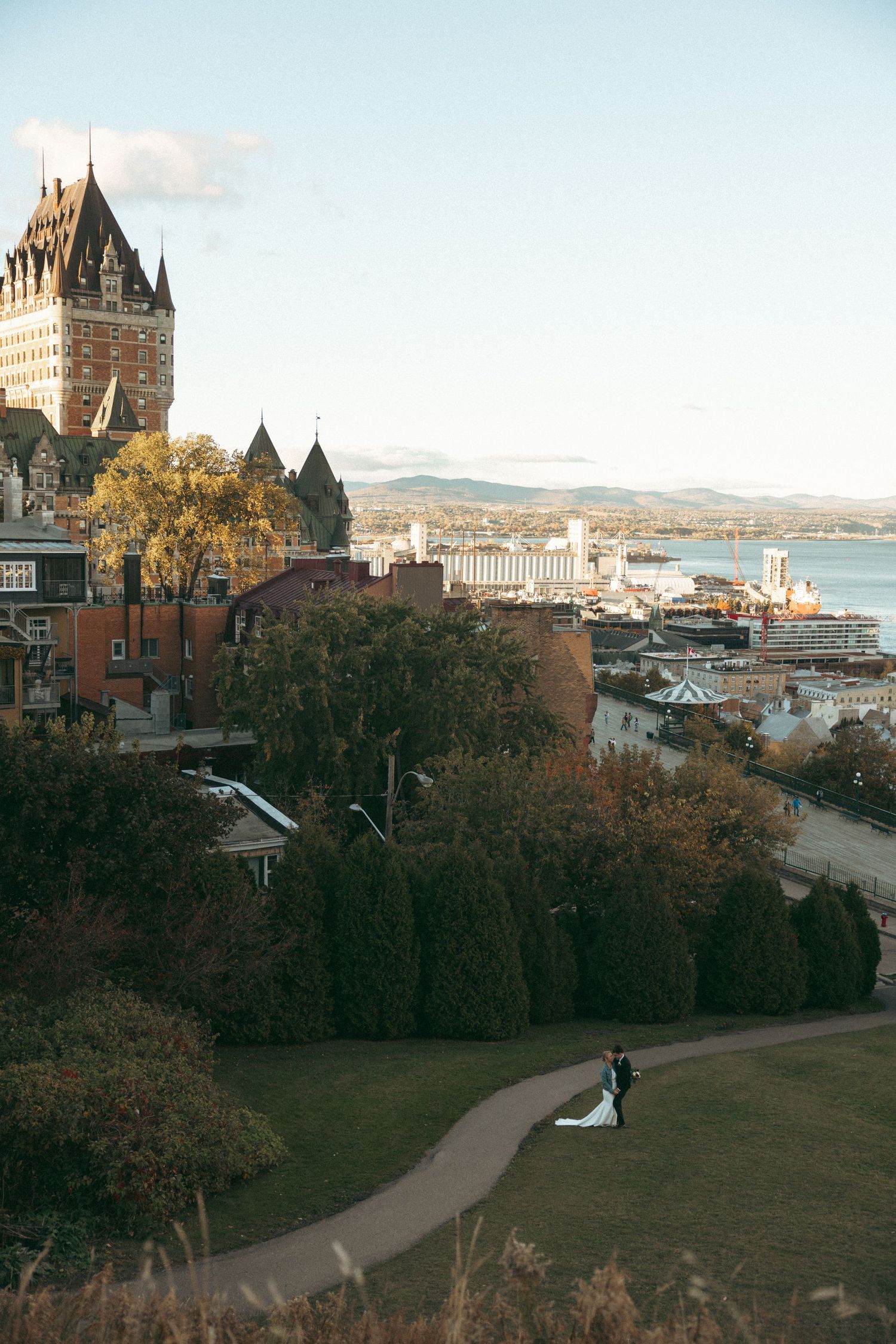 Panoramic view of Quebec City's historic Chateau Frontenac and surrounding cityscape during autumn.