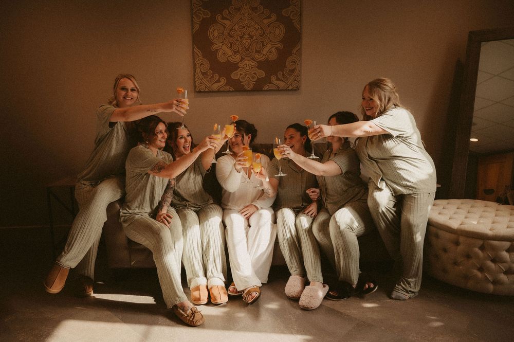 Group of people in white shirts lounging and relaxing together on a couch in a casual indoor setting.