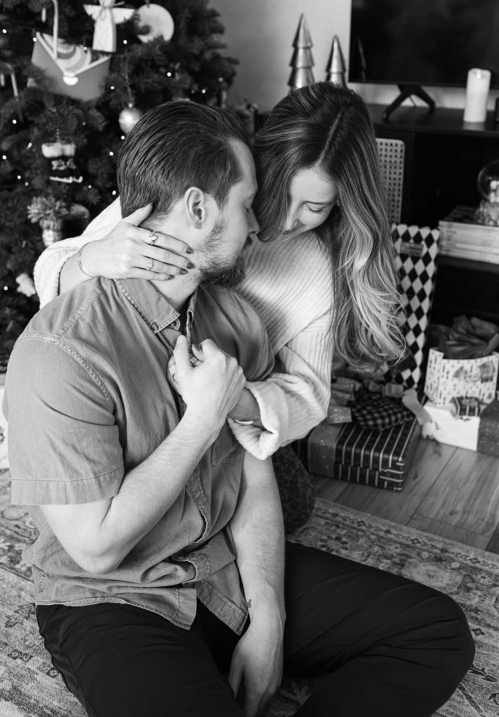 A romantic black and white photo series showing tender moments between a couple on a couch.