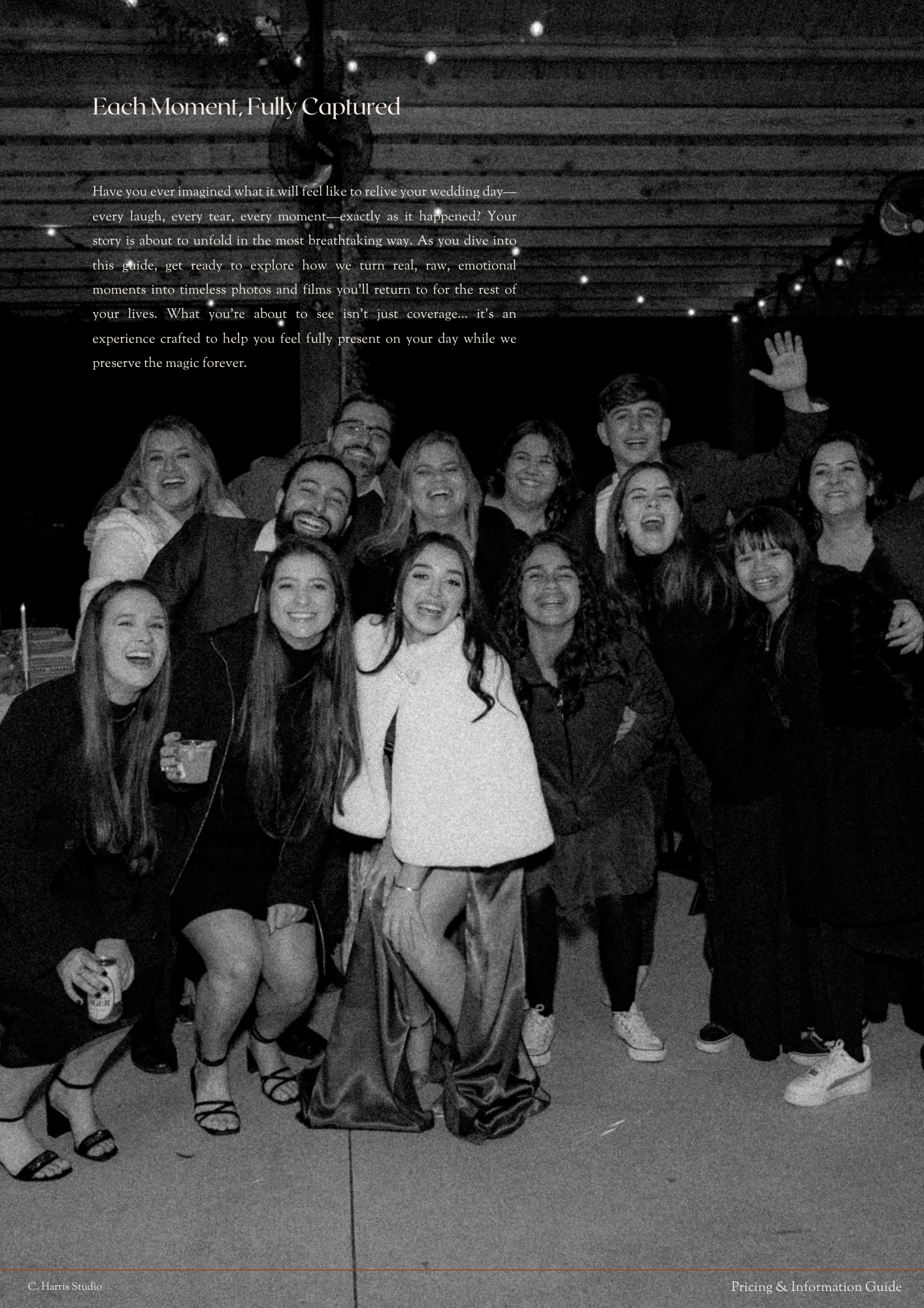 A black and white panoramic photo shows a group sitting together on the floor in a casual setting.
