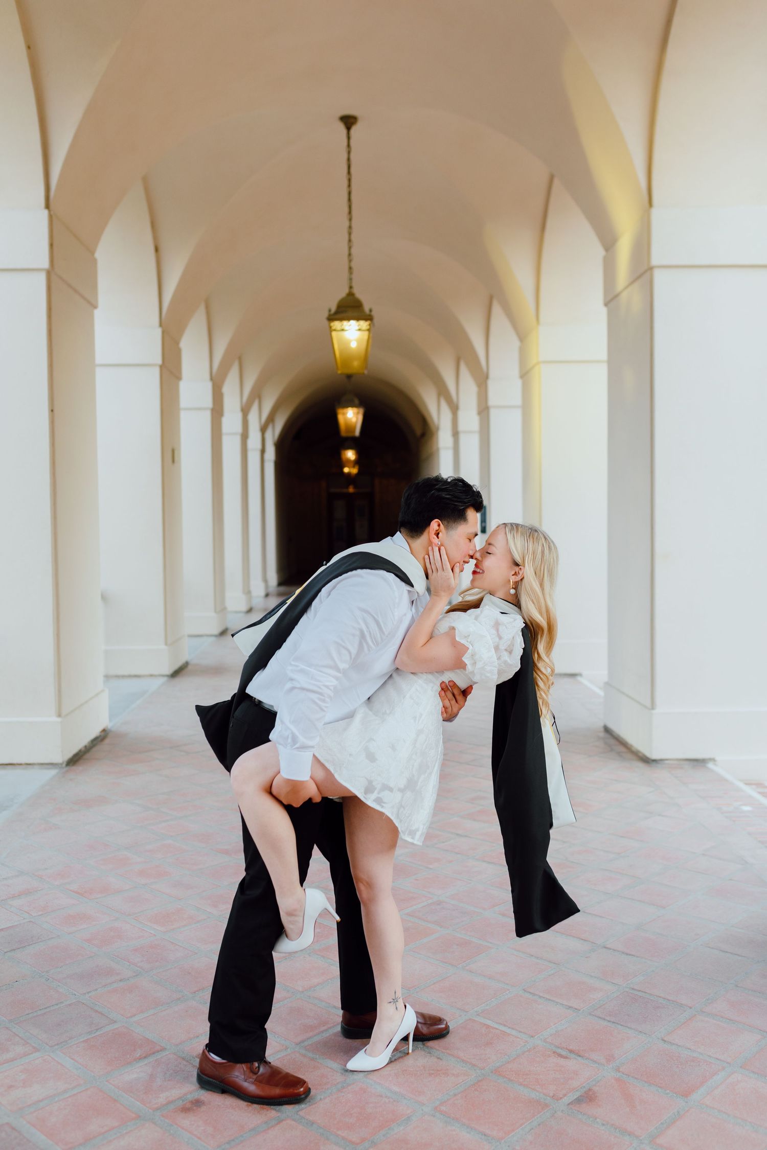 Couple shares a kiss for their couples graduation photoshoot. Taken by a Bay Area Graduation Photographer