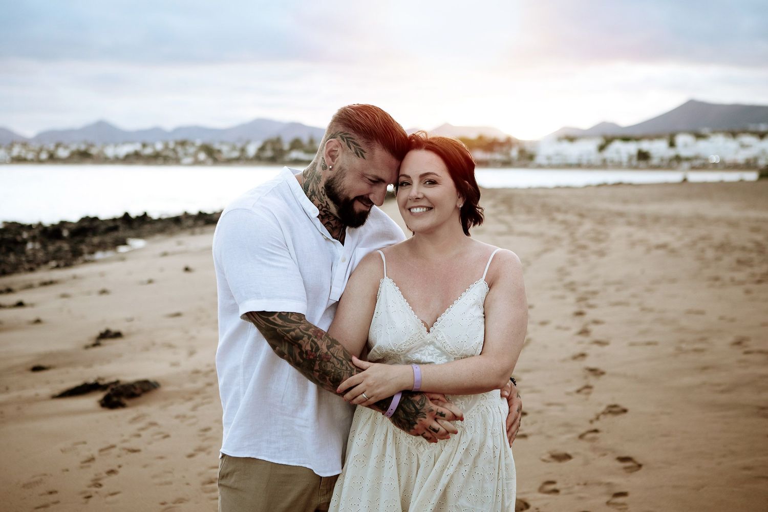Couple embracing during a vow renewal on a Lanzarote beach - Wedding photographer in Lanzarote and Fuerteventura photoFuerte
