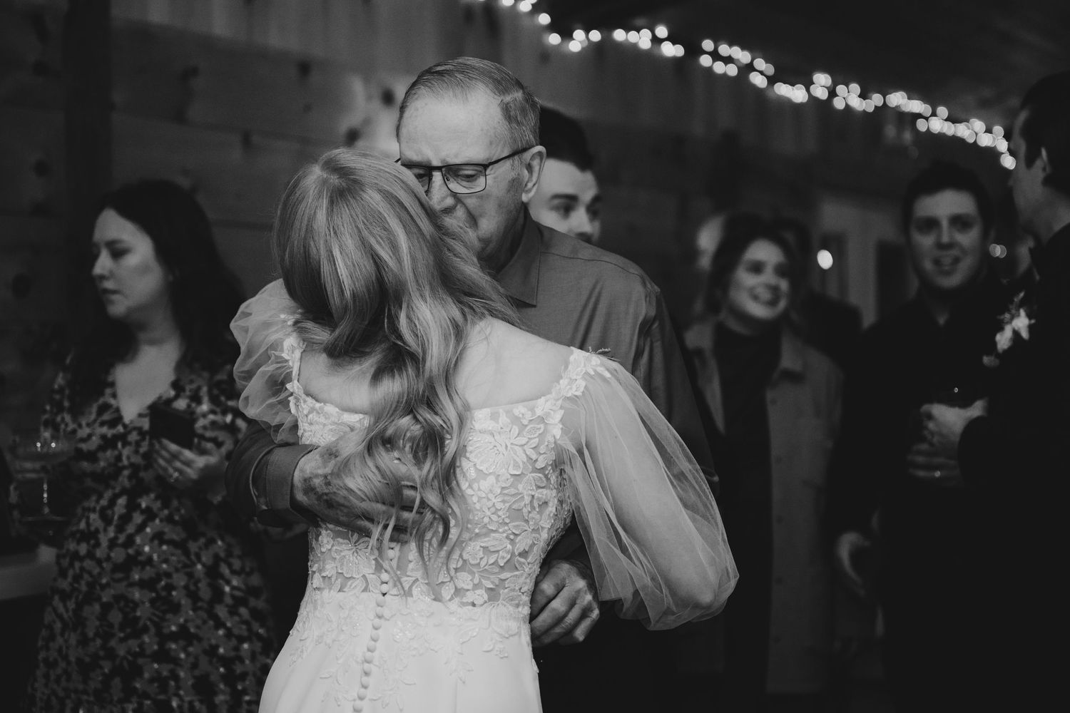 A black and white photo montage showing multiple dance scenes at a wedding reception.