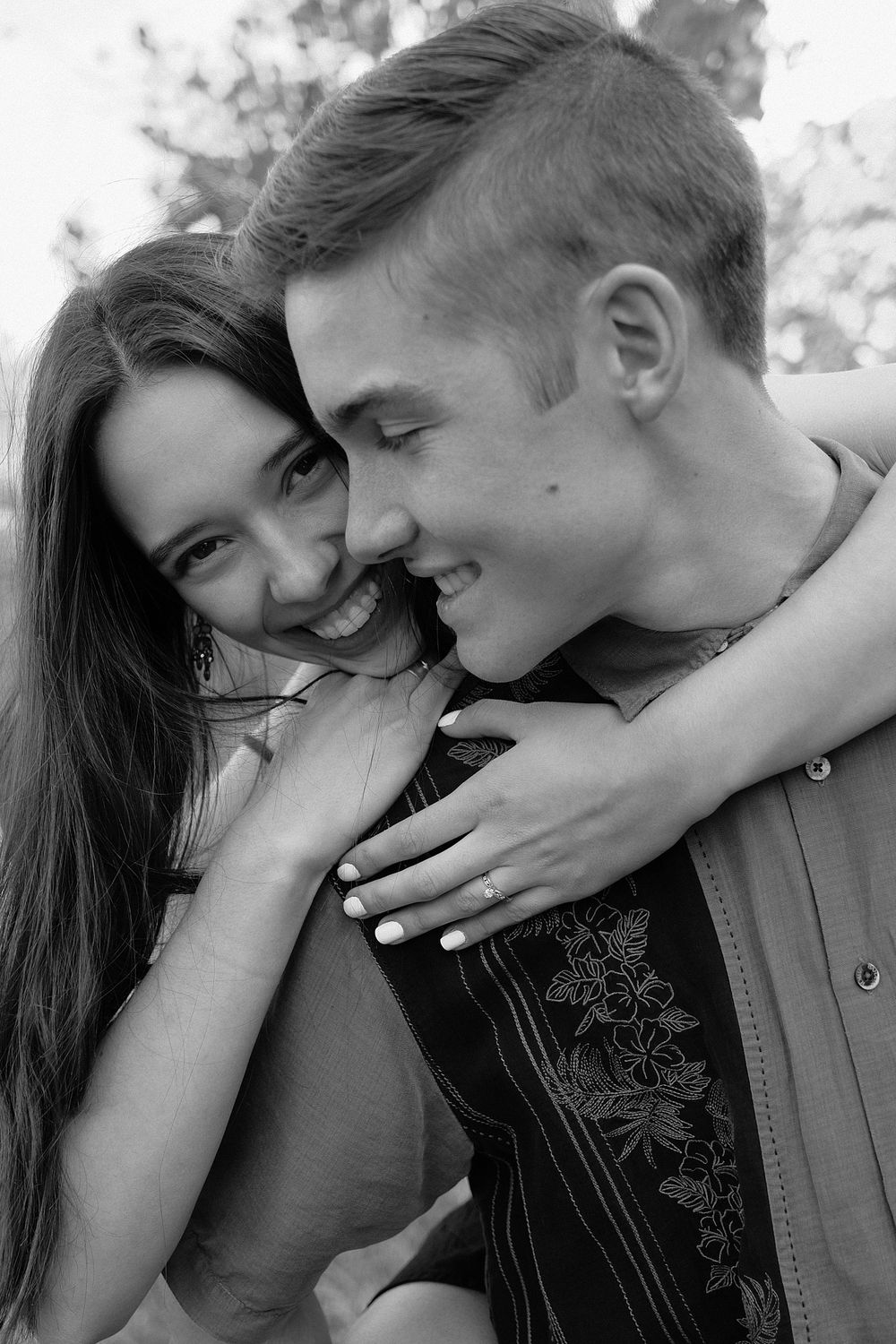 A series of four black and white romantic photos showing a couple embracing and sharing tender moments together.