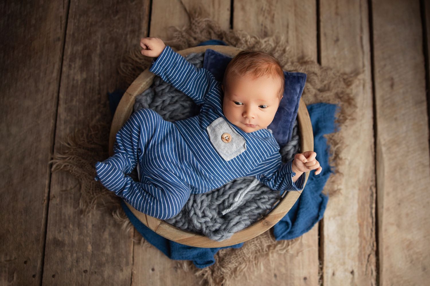 Alert newborn baby with open eyes captured in a studio newborn photoshoot in Nashville area