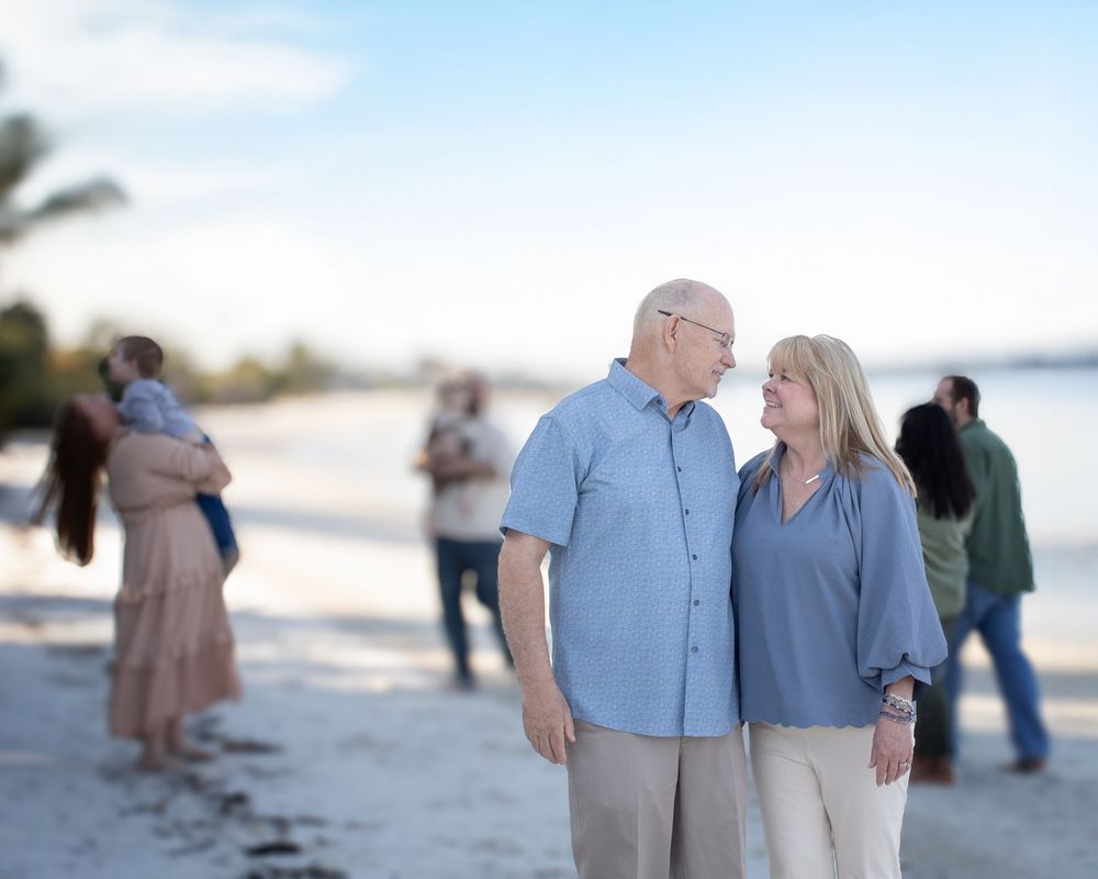 Couples strolling along the shoreline at sunset while enjoying a peaceful beach moment.