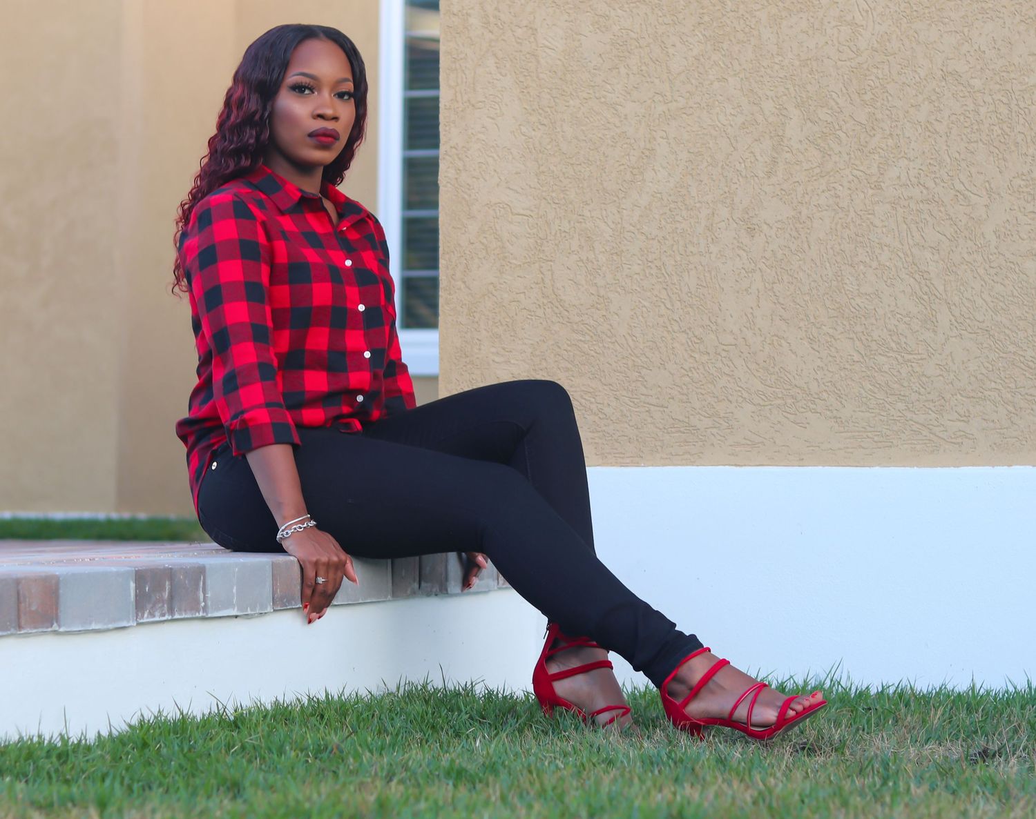 Fashion portraits featuring someone in red plaid and black attire against a neutral wall.