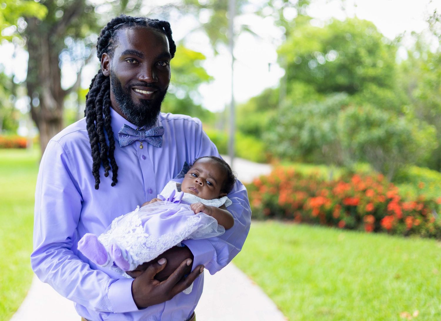 Outdoor family portrait session in a lush garden setting.