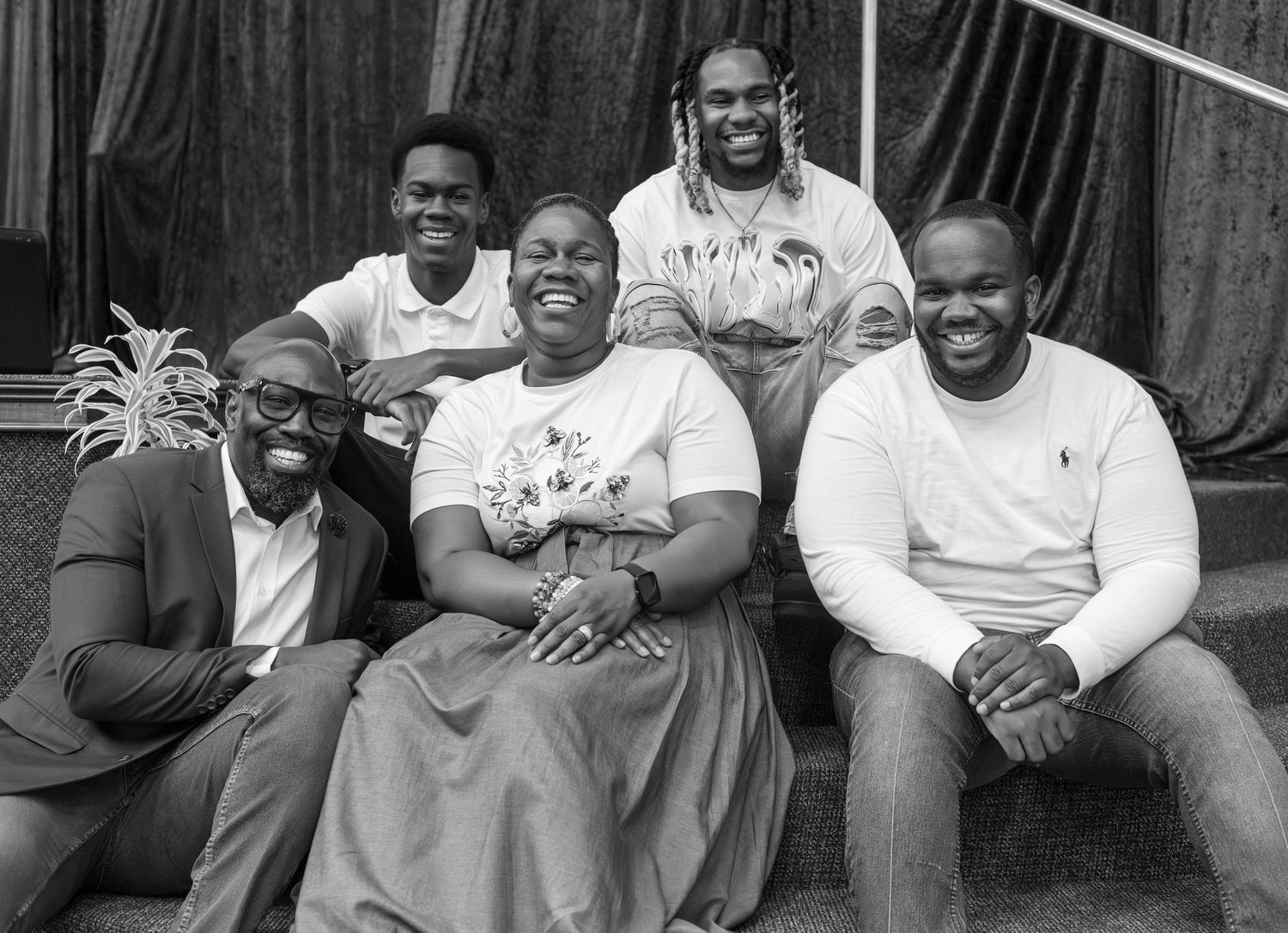 A series of black and white portraits showing candid moments and laughter.